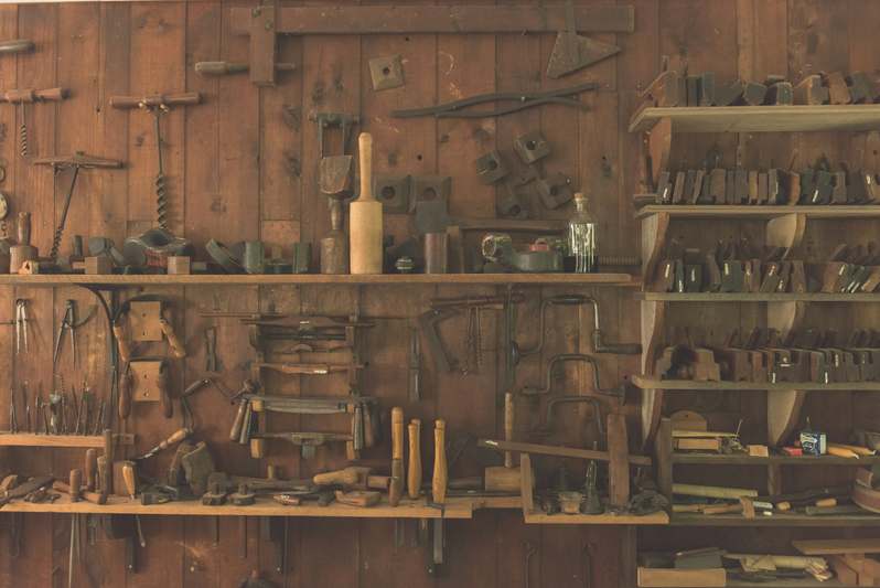 Split image: left side shows a well-organized beginner’s workspace with clamp, tape measure, pencil, and sander; right side shows an instructor demonstrating proper hand-plane grip